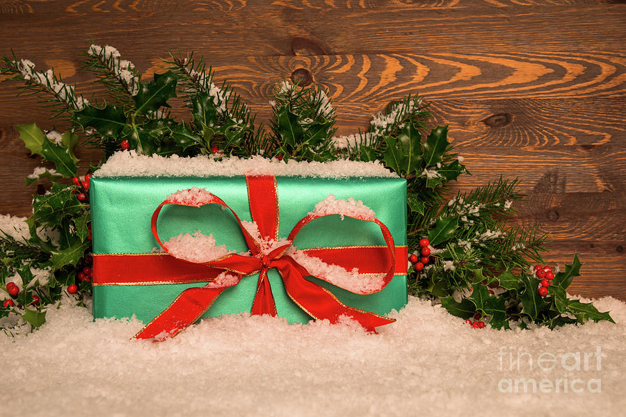 Christmas Present Wrapped In Green Paper With Red Ribbon Photograph