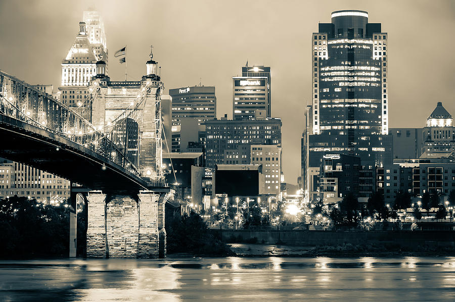 Cincinnati Skyline Photograph - Cincinnati Skyline And The John A. Roebling Suspension Bridge - Sepia by Gregory Ballos