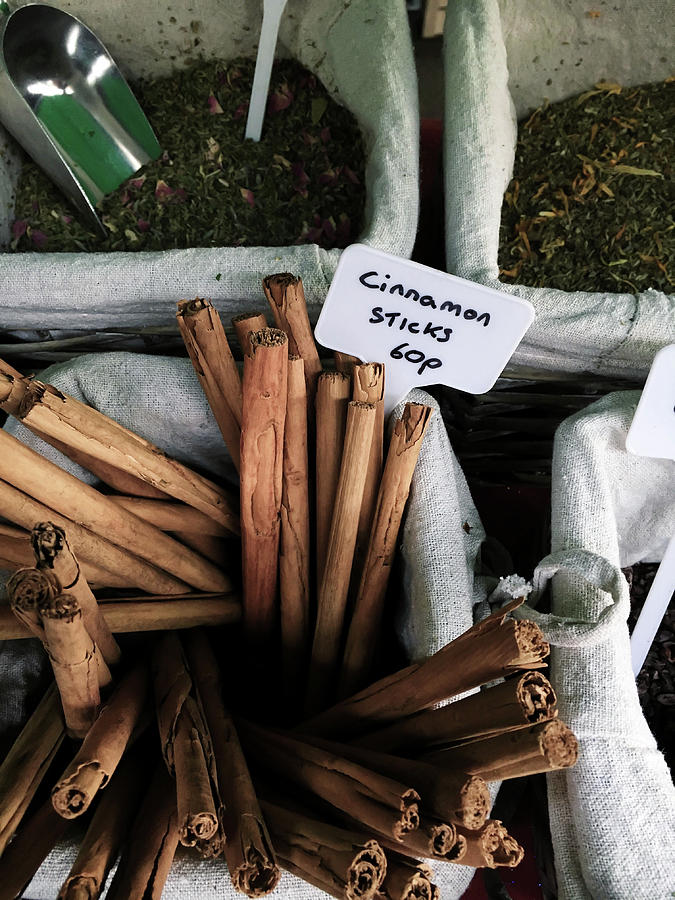 Cinnamon sticks on sale at a market Photograph by Tom Gowanlock