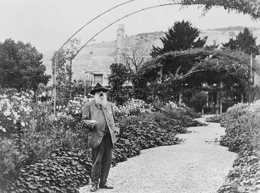 Claude Monet in his garden Photograph by French School