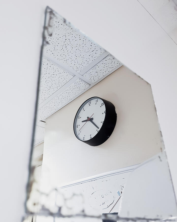 Clock in the mirror Photograph by Tom Gowanlock