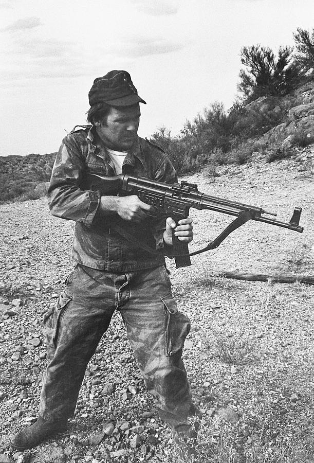 Close up Barry Sadler shooting another type  of his numerous  machine guns  Tucson Arizona 1971 Photograph by David Lee Guss