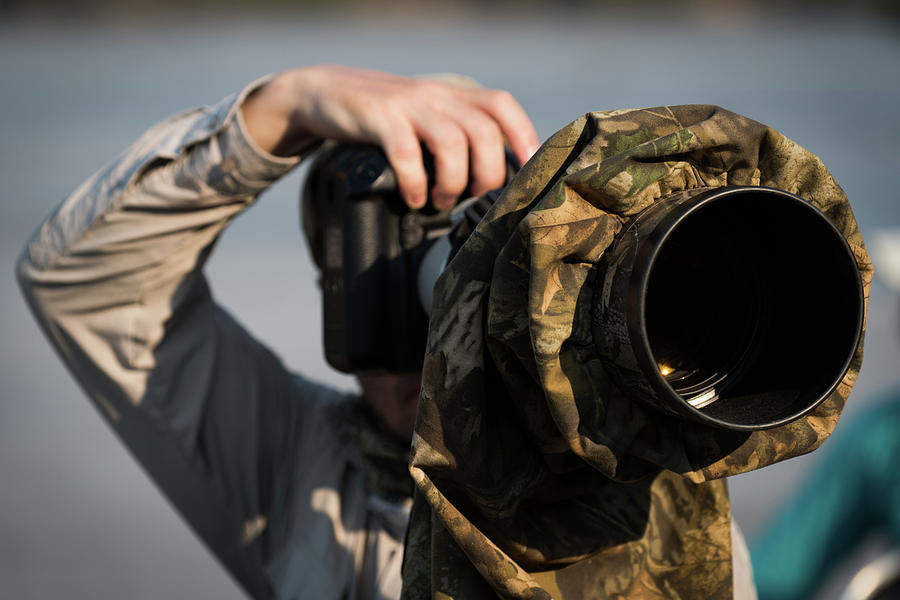 Close-up of photographer pointing camera in cover Photograph by Ndp ...