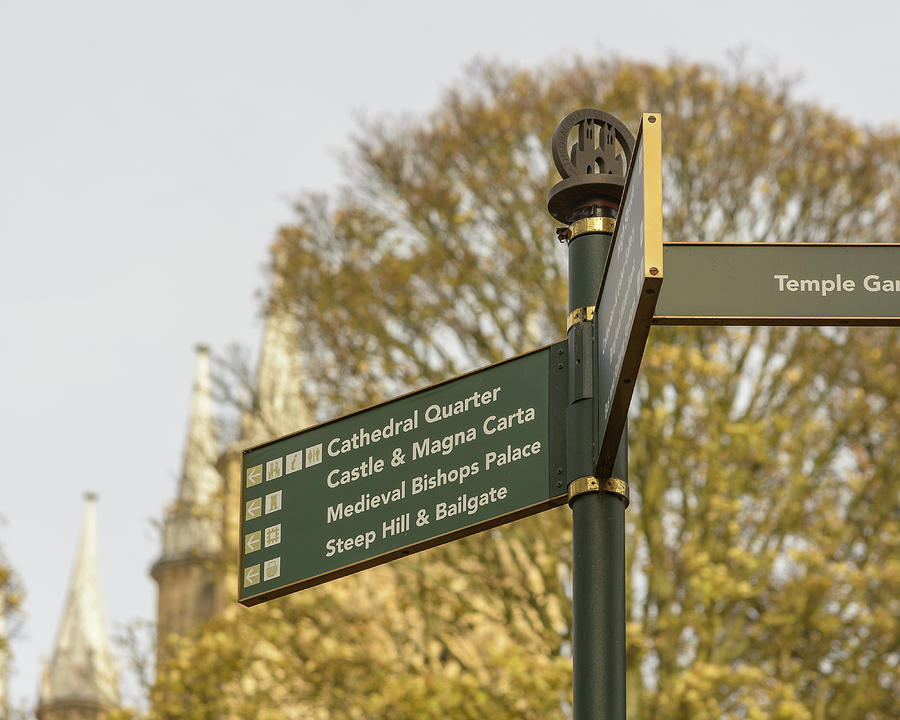 Architecture Photograph - Close up of Tourist Information Directing Sign in Lincoln Cathedral Quarter by Jacek Wojnarowski