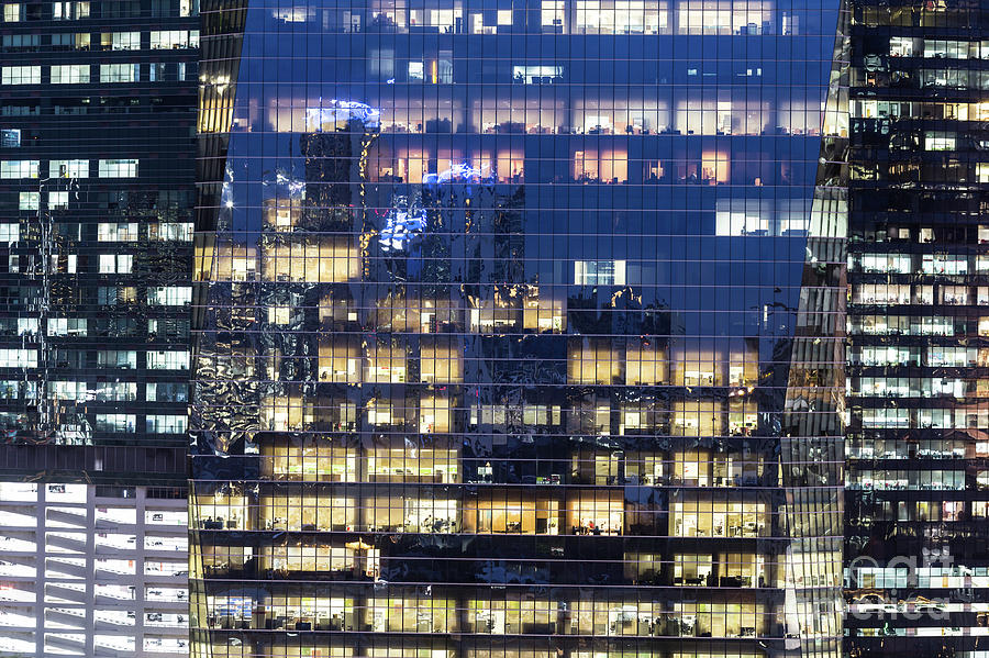 Close up view of 3 different office building facade at night in  Photograph by Didier Marti