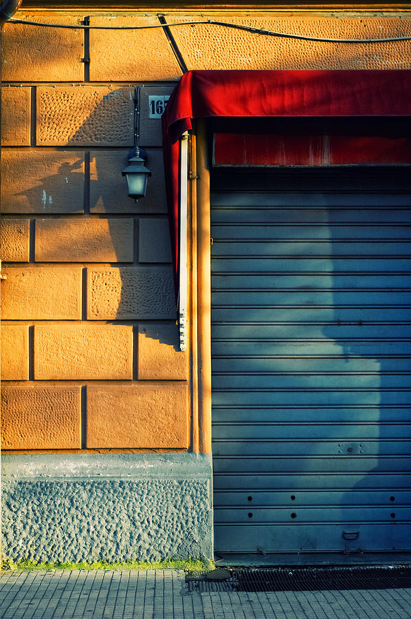 Sunset Photograph - Closed shop door at sunset by Silvia Ganora