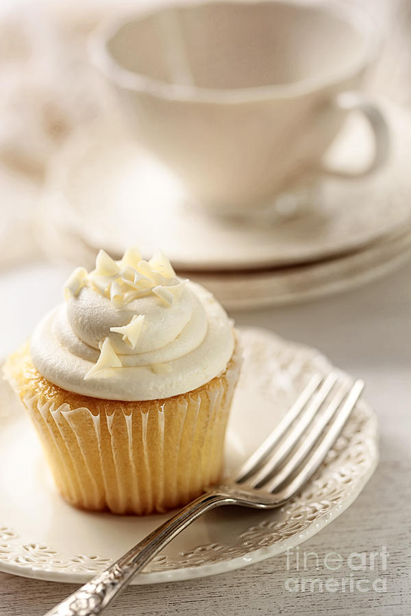 Cake Photograph - Closeup of vanilla cupcake with tea cup by Sandra Cunningham