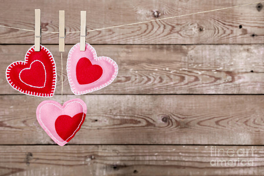 Clothesline with Valentine's Day hearts decorations on a rustic ...