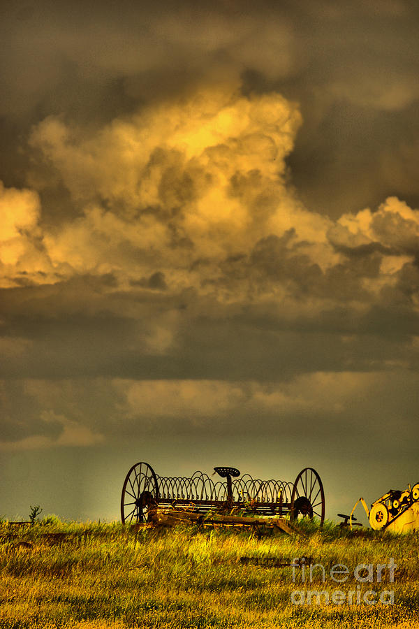 Cloud over farm equipment Photograph by Jeff Swan
