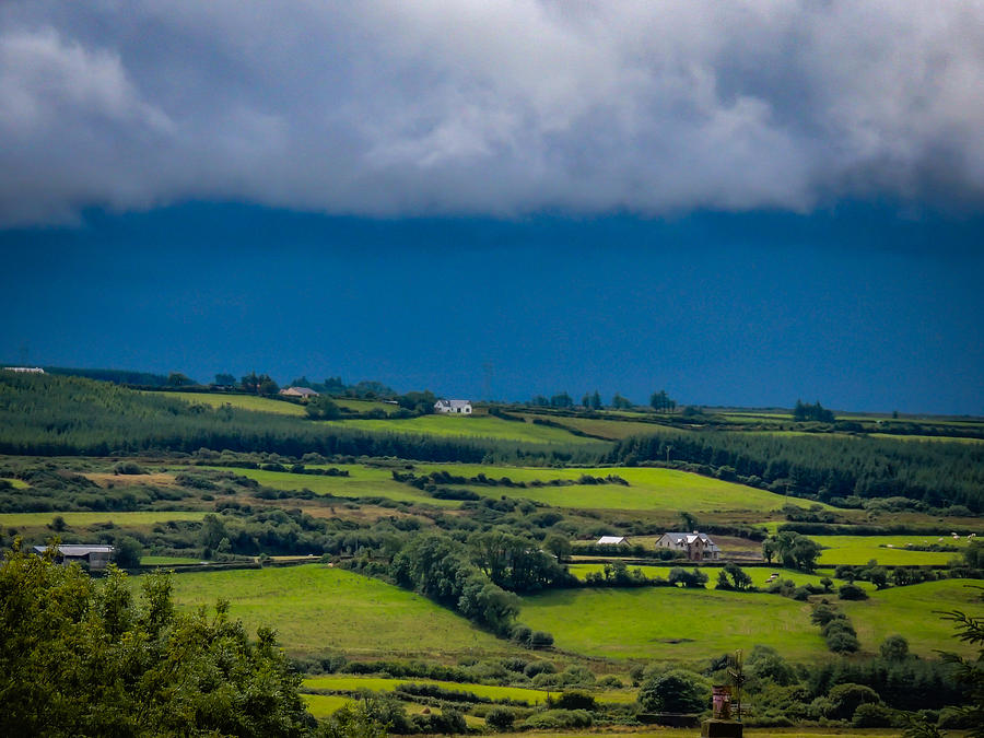 Clouds over Shimmering Green Irish Countryside Photograph by James Truett