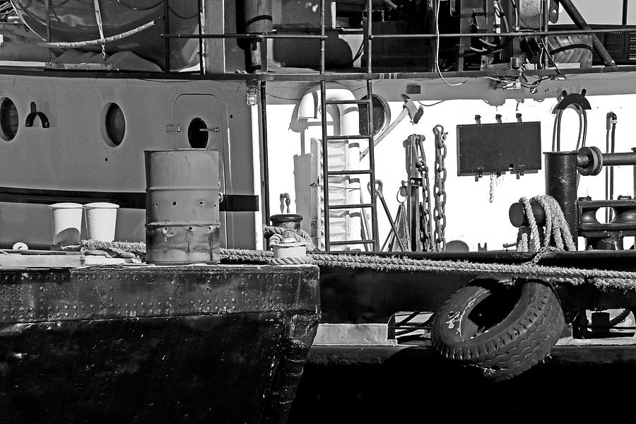 Cluttered Dock and Boat BW Photograph by Mary Bedy