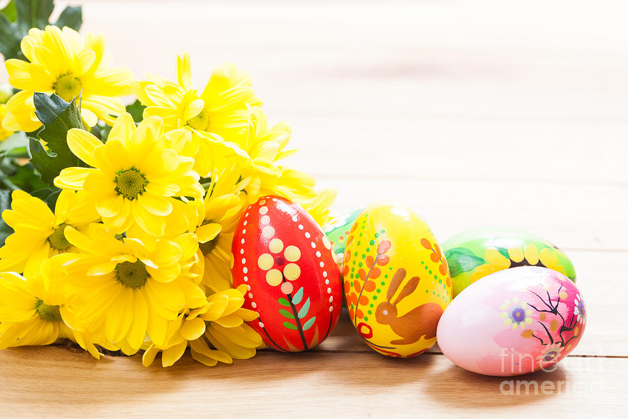 Colorful hand painted Easter eggs and spring flowers on wood Photograph by Michal Bednarek