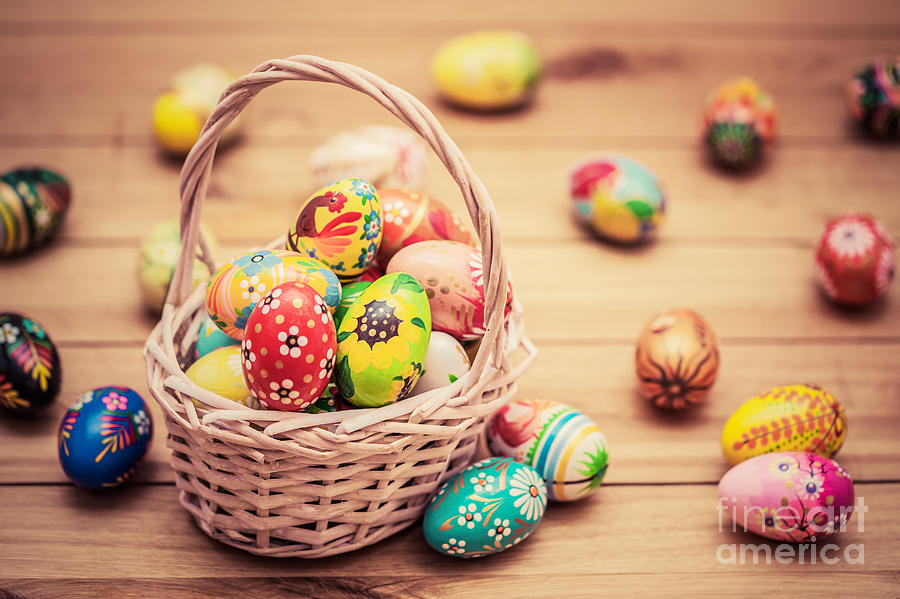 Colorful hand painted Easter eggs in basket and on wood Photograph by Michal Bednarek