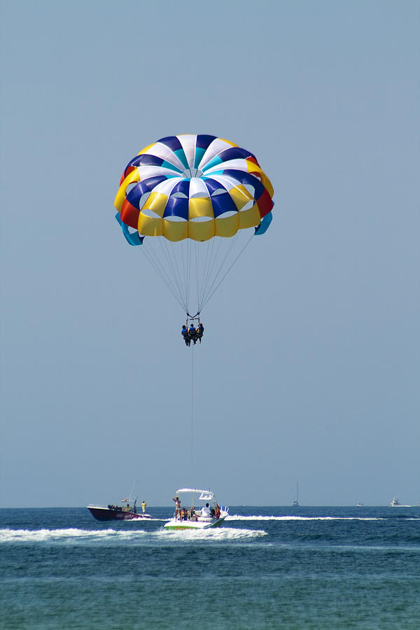 Boat Photograph - Colorful Parasailing by Kathy Clark