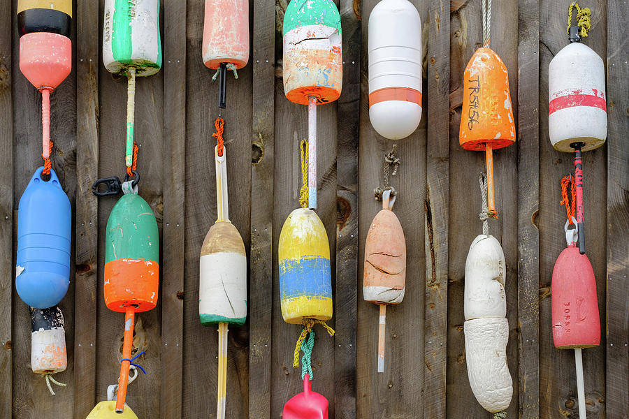 Colorful retired buoys hang on an old Lobster Fishing Shack by Jorge Moro