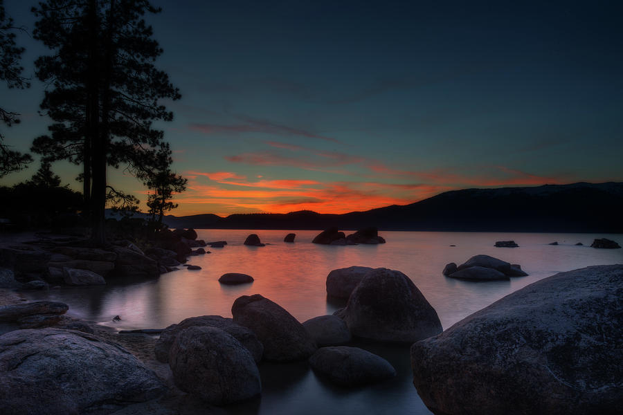 Colorful sunset behind mountains at Lake Tahoe Photograph by Dan Friend