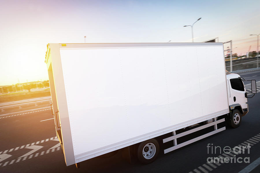Transportation Photograph - Commercial cargo delivery truck with blank white trailer driving on highway by Michal Bednarek
