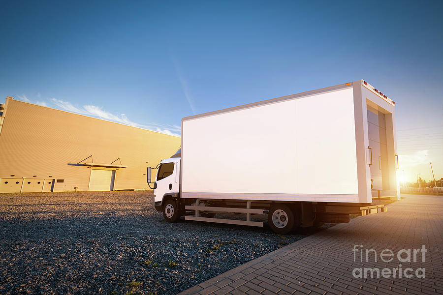 Commercial delivery truck with blank white trailer on cargo parking. Photograph by Michal Bednarek