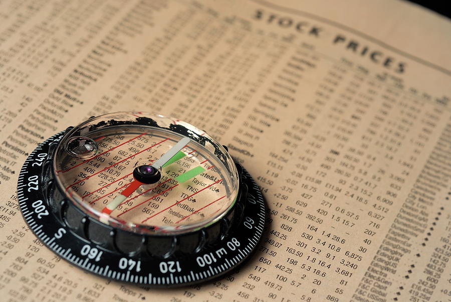 Newspaper Photograph - Compass on stockmarket cotation in newspaper by Sami Sarkis