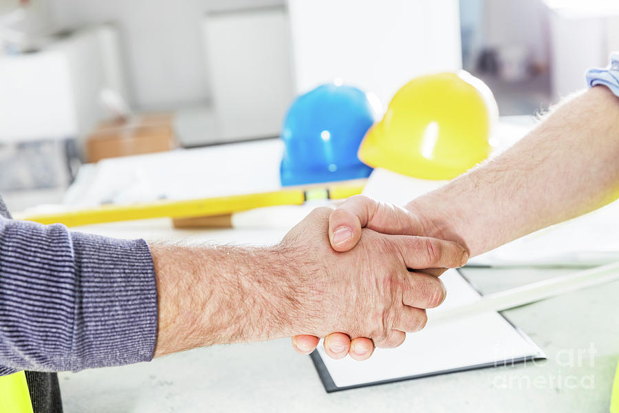 Construction engineers handshake. Photograph by Michal Bednarek