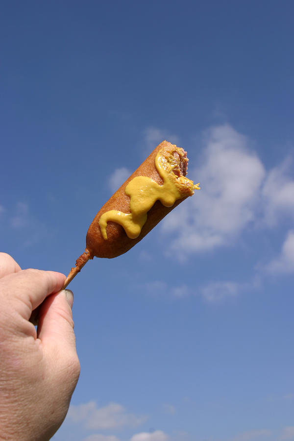 Corndog in the sky with mustard Photograph by Mike Ledray