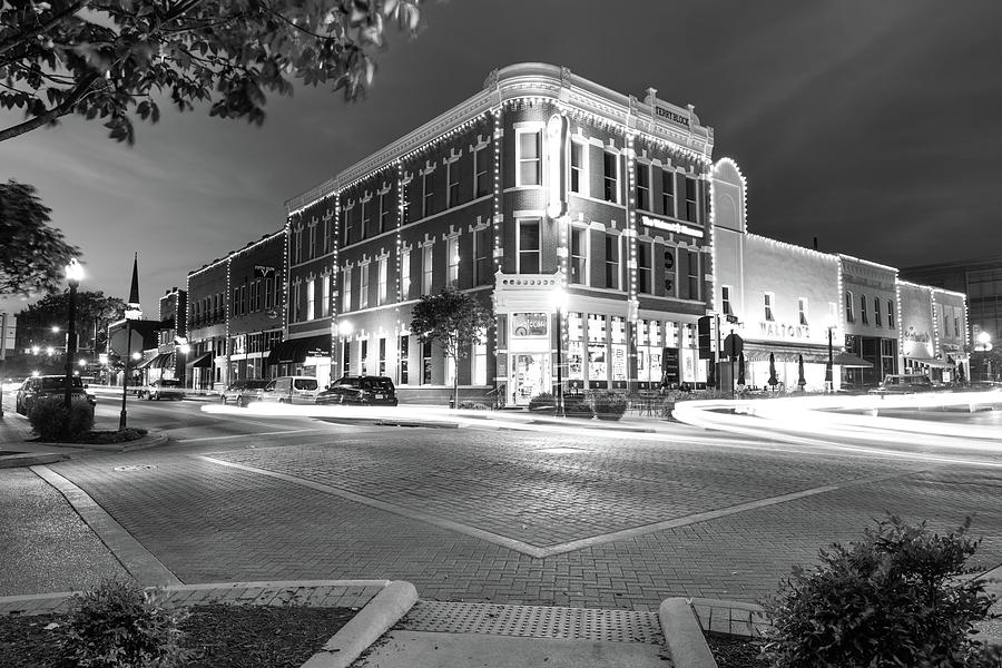 Black And White Photograph - Corner View in Black and White- Downtown Bentonville Arkansas Town Square at Night by Gregory Ballos