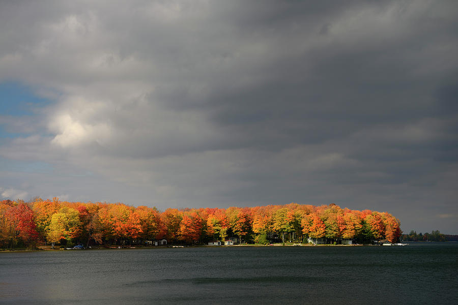 Cottages on Lake Eugenia with red sidelit maple trees and storm  Photograph by Reimar Gaertner