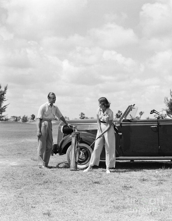 Couple Golfing Beside Car, C.1930s Photograph by H. Armstrong Roberts/ClassicStock