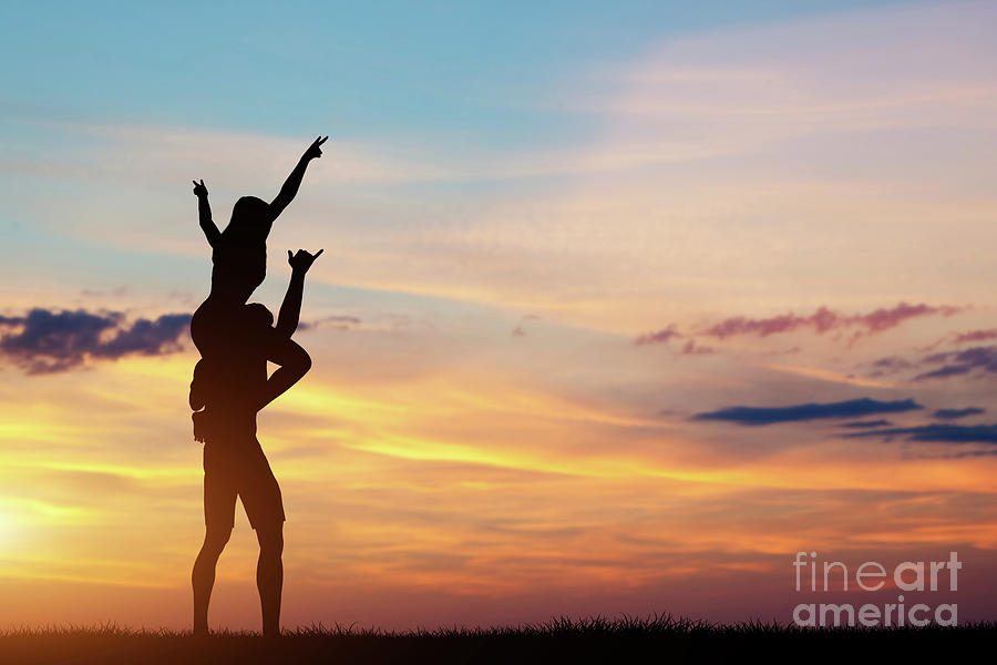 Couple having happy time together at sunset. Photograph by Michal Bednarek