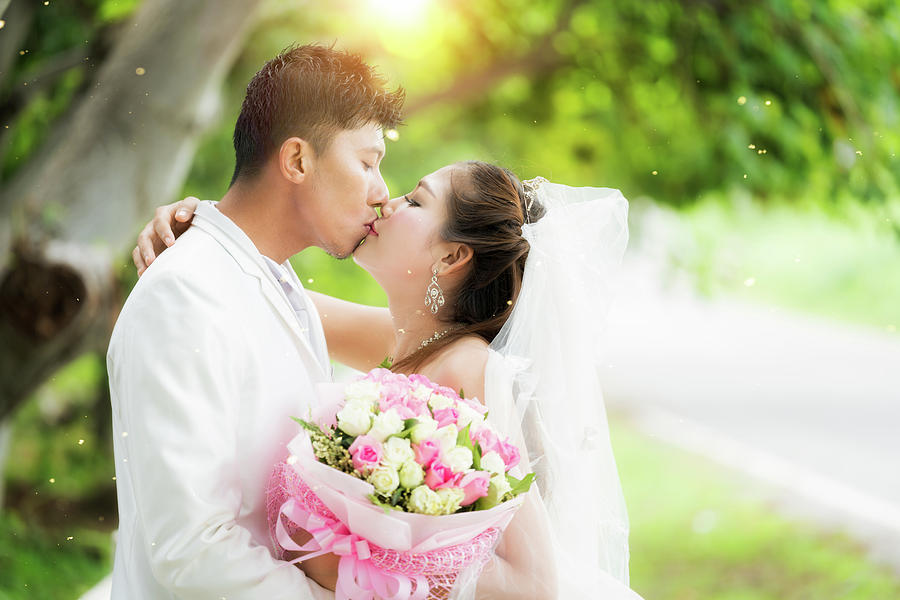 Couple just wedding hug and kiss in nature background Photograph by Anek Suwannaphoom