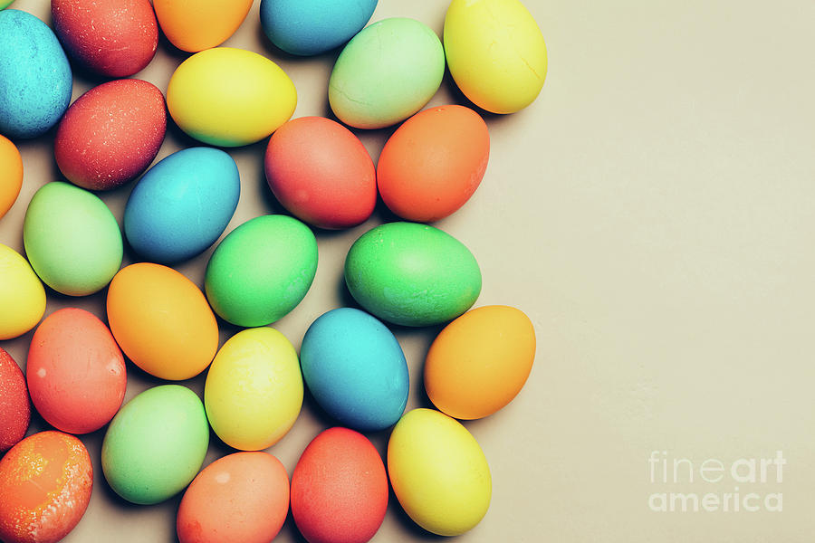 Couple of dyed eggs laying on a creamy background. Photograph by Michal Bednarek