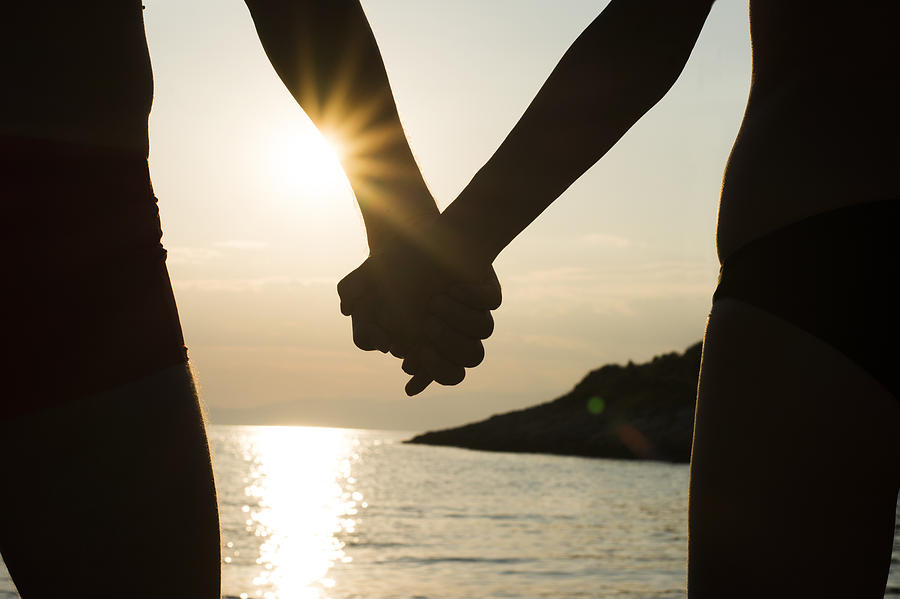 Couple Holding Hands On Beach
