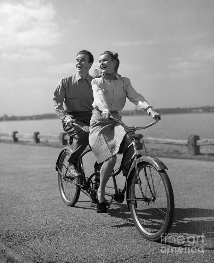Couple On Tandem Bicycle, C.1950s Photograph by Debrocke/ClassicStock