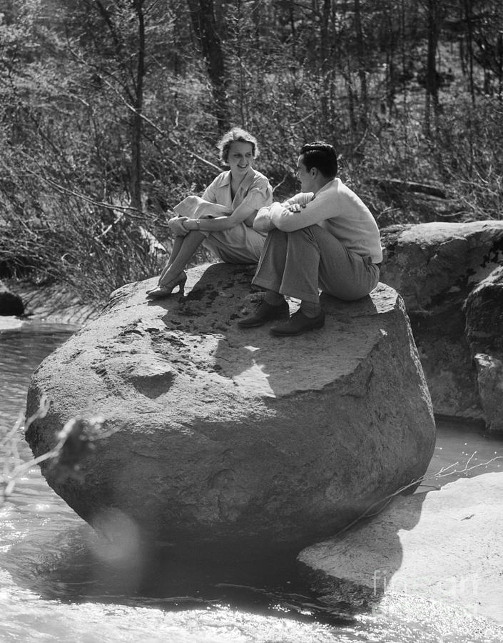 Couple Sitting On Large Rock, C.1930s Photograph by H. Armstrong Roberts/ClassicStock