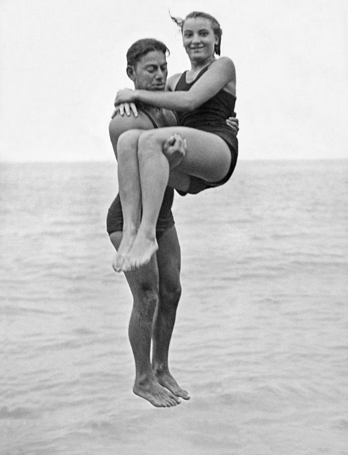 Couple Tandem Leaps Into Lake Photograph by Underwood Archives