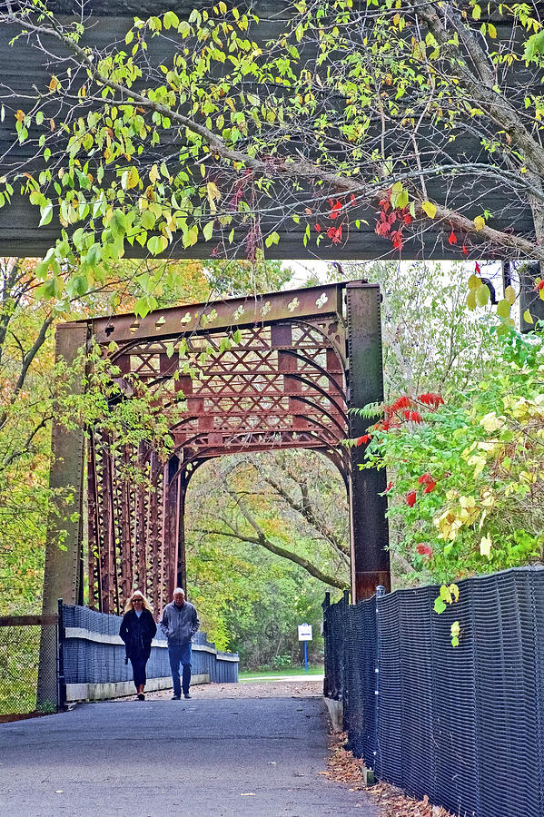 Couple Walking across Bridge on White Pine Trail in Kent County, Michigan Photograph by Ruth Hager