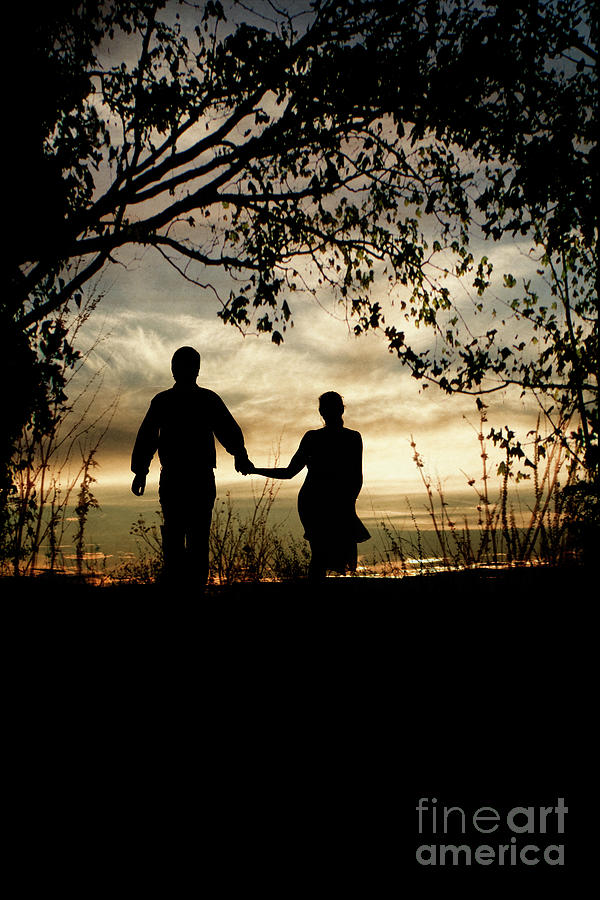 Couple walking at sunset Photograph by Clayton Bastiani