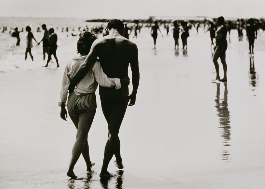Black And White Photograph - Couple Walking in the Water at Coney Island by Nat Herz