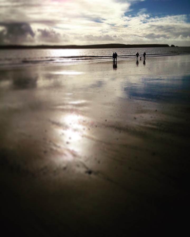 Couples walking on a beach Photograph by Seeables Visual Arts