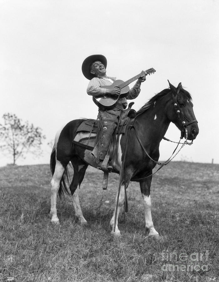 Cowboy On Horse Singing And Playing Photograph by H. Armstrong Roberts/ClassicStock