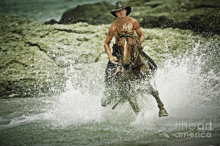 Cowboy riding horse across the river Photograph by Dimitar Hristov