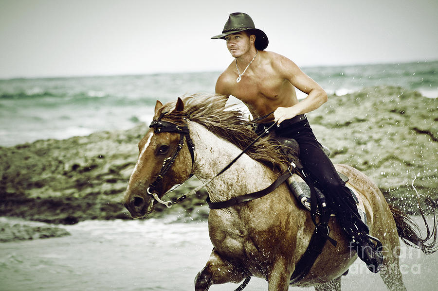 Cowboy riding horse on the beach Photograph by Dimitar Hristov