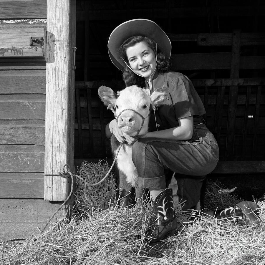 Cowgirl With Calf In Barn, C. 1940s-50s Photograph by B. Taylor/ClassicStock
