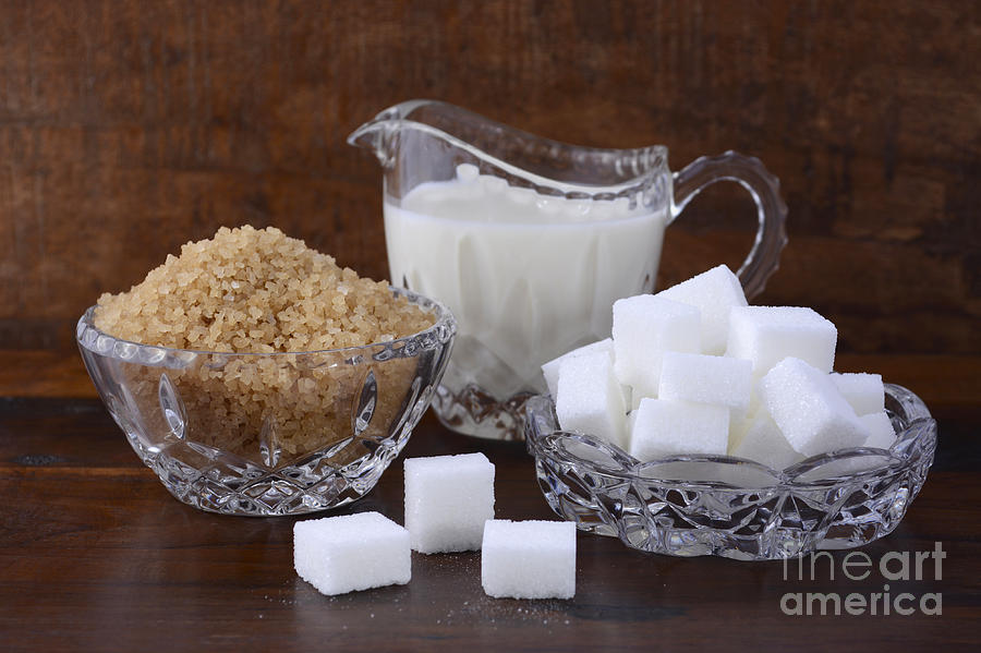 Cream and sugar in crystal glassware.  Photograph by Milleflore Images