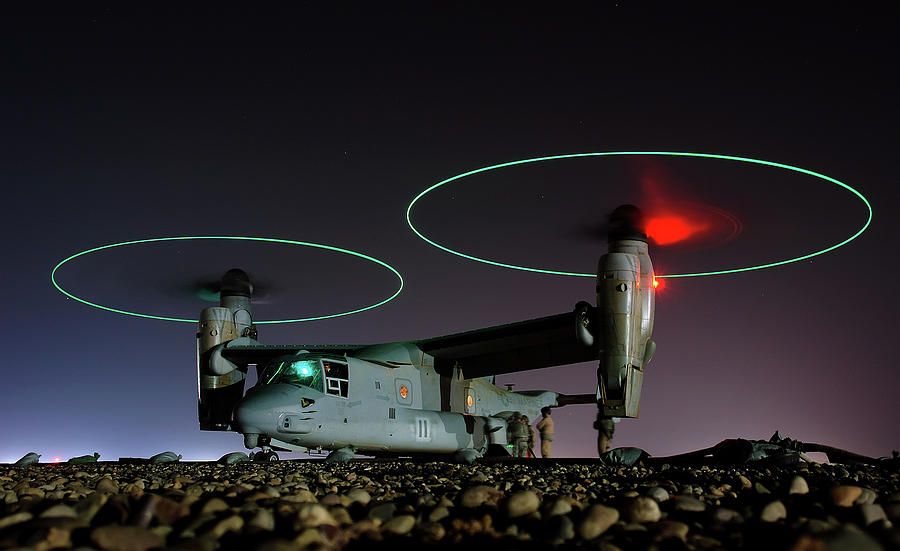 Crew members refuel an A V 22 Osprey before a night mission in central Iraq Photograph by Paul Fearn