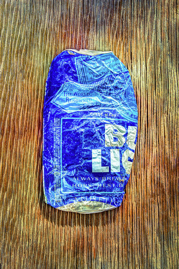 Crushed Blue Beer Can on Plywood Photograph by YoPedro