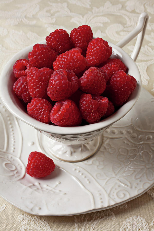 Cup Photograph - Cup full of raspberries  by Garry Gay