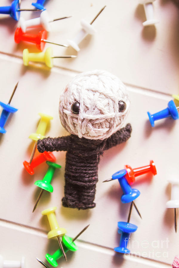 Cute doll made from yarn surrounded by pins Photograph by Jorgo Photography