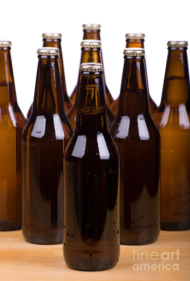 Dark Brown Glass Bottles Full Of Beer On White  Photograph by Arletta Cwalina