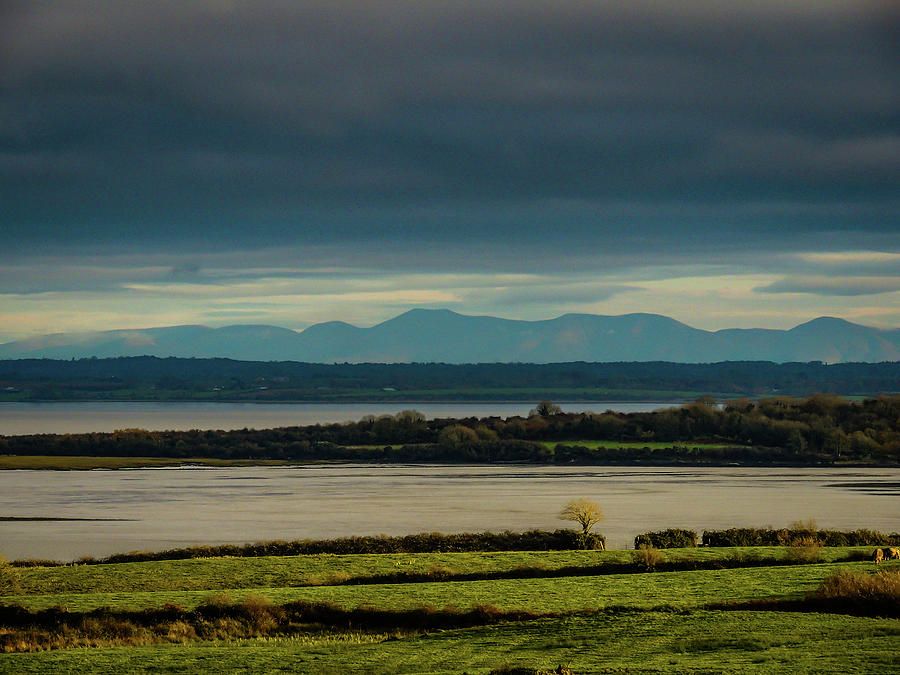 Dark skies over Irelands Shannon Estuary Photograph by James Truett Dark skies over Irelands Shannon Estuary Photograph by James Truett